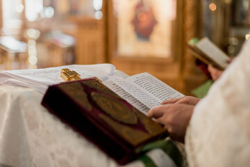 Priest reading from the Holy Bible during a church service. Integral to Christian worship and spiritual guidance - obrazy, fototapety, plakaty