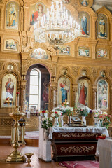 Orthodox church interior with iconostasis and ornate chandelier. Spiritual ambiance for worship,...