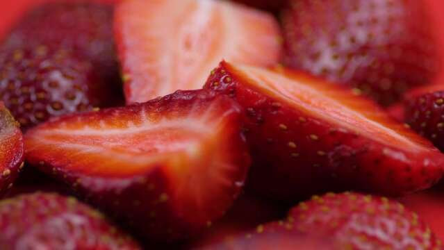 Appetizing strawberries cut into slices rotation, macro photography.. The pleasure of strawberry pieces