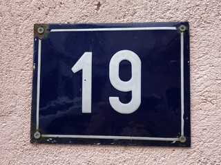 Blue metal numberplate that says number 19