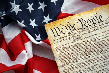 Preamble to the Constitution of the United States and American Flag. Old yellow paper with We The...