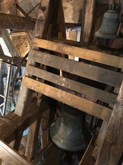 Bells inside an old wooden structure in bell tower