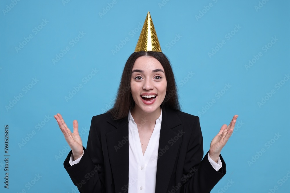 Canvas Prints Happy woman in party hat on light blue background