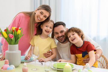Easter celebration. Portrait of happy family at served table in room