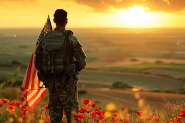 Gordijnen Soldier with flag at sunrise in a poppy field. Memorial day. © Larisa