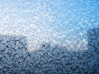 frost on window glass of city apartment on cold winter