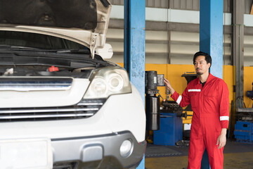 Male mechanic working at garage. Professional Asian male mechanics checks, repair and maintenance...