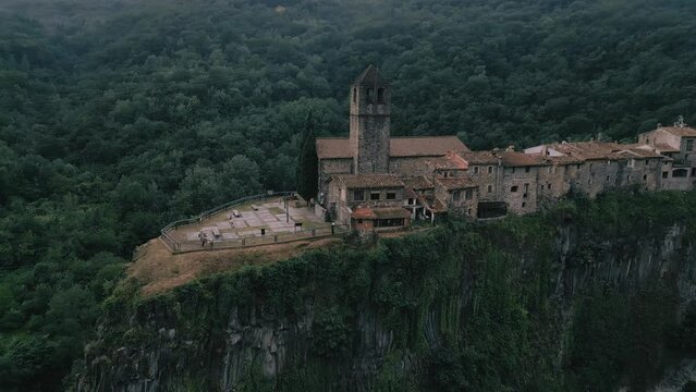 Castellfollit de la Roca - 4K Drone Aerial Flyover - epic landscape of churches, cliffs, canyons, villages and forests - Catalonia Spain - incredible