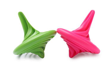 Green and pink spinning tops isolated on white