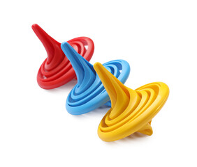 Obraz premium Three colorful spinning tops on white background