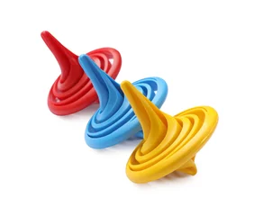 Tapeten Three colorful spinning tops on white background © New Africa