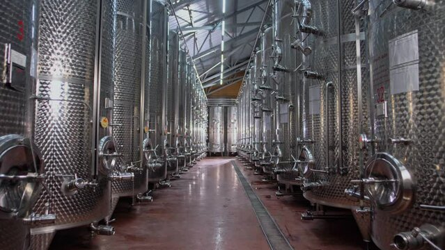 Large chrome plated tanks for storing and fermenting wine products. Modern clean wine production plant