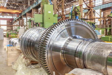 Steam turbine rotor in a factory workshop.