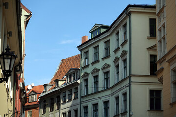 Fototapeta na wymiar Top floors of beautiful vintage colorful houses on Jauniela street in Riga old town in sunny cloudless day