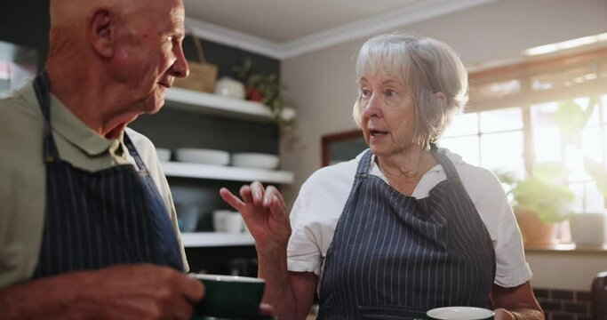 Senior, couple and talking with coffee in kitchen to help chef with cooking breakfast or brunch in retirement. Elderly, man and woman together in home with conversation about morning or drink
