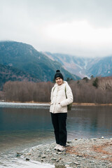Woman tourist travel Kamikochi National Park, happy Traveler sightseeing Taisho pond with mountain,...