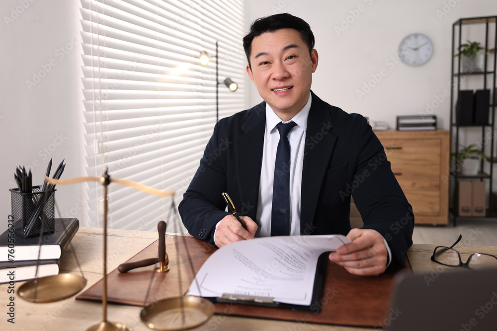 Poster Happy notary writing notes at wooden table in office