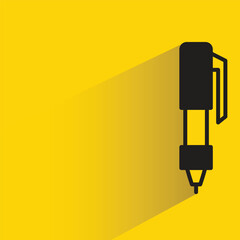 pen with shadow on yellow background