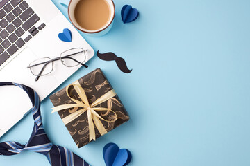 Father's day gift guide: top view shot of wrapped present, tie, laptop, glasses, and heart shapes on a sky blue background with space for personalized messages