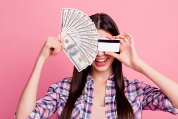 Close-up portrait of her she nice attractive cute charming lovely cheerful cheery straight-haired lady hiding behind cash card shopaholic isolated over pink background - obrazy, fototapety, plakaty