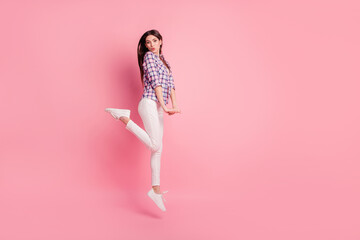 Full length side profile body size photo funny beautiful her she lady jump high send air kisses wear shoes casual checkered plaid shirt white jeans denim clothes outfit isolated pink background