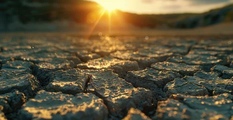 Foto op Plexiglas A beautiful sunset over dry, cracked earth. Perfect for environmental themes © Ева Поликарпова