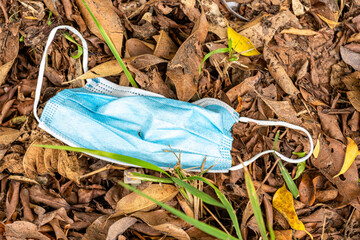 Discarded mouth or face blue paper mask
