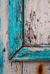 Detail on ancient wooden structure with worn paint in seaside fishing village