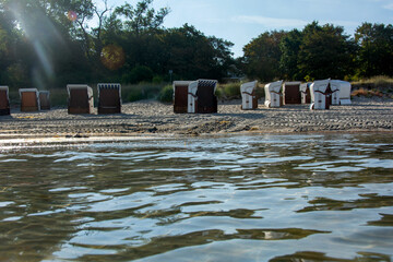 Water with a view of beach chairs in the background