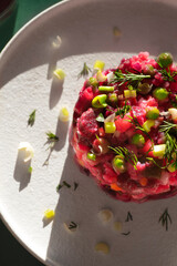 Summer light beet salad with boiled vegetables in the bright summer sun. Vinigret, Slavic and Scandinavian  cuisine, vegetarian recipes and dietary recipes