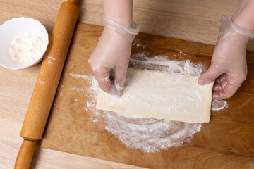 Preparation and rolling out puff pastry. Preparation of puff pastry dishes.