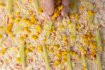 Stuffing, cucumber and corn are added to the unfolded pita bread. Preparation of pita bread roll.