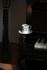 The white coffee cup put on vintage piano key - 760653443