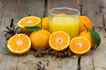 orange juice and some fresh fruits on wooden background