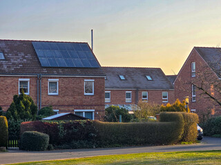 old brick houses during morning hours, roof with solar panels