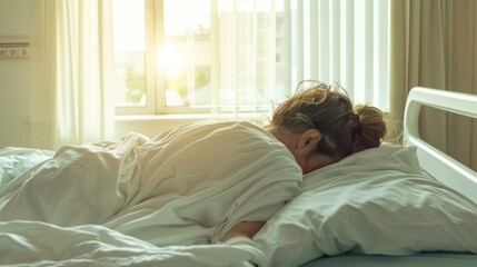Back view of sick woman sleeping on side in hospital bed  - obrazy, fototapety, plakaty