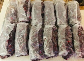 Wild cranberries in transparent bags of two hundred grams are lying on the table. Preparation for...