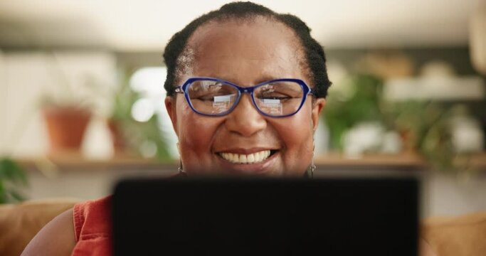 Glasses, tablet and senior black woman on a sofa reading ebook, social media or funny gif at home. Digital, app and face of old African person with online comic, show or Netflix and chill in a house