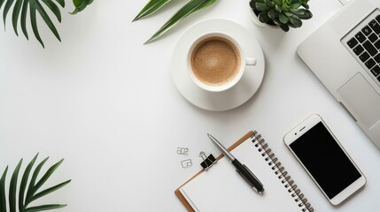 Working place with notepad, pen, smart phone, laptop and cup of coffee over white background. Top...