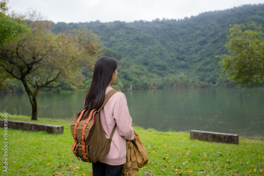 Wall mural woman enjoy the lake view in the countryside