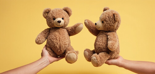 Two hands touching or holding from different sides plush toy to represent parental care and custody - obrazy, fototapety, plakaty