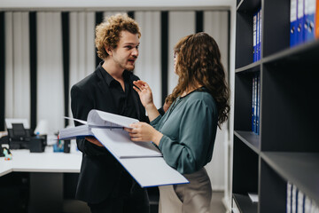 A couple strategizing together in an indoor office, discussing business growth and market analysis....