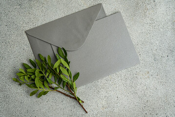 Grey envelop with pistachio branches