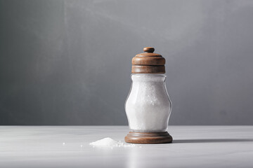 salt shaker on gray table on grey background