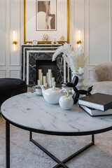 modern living room in a historical style with a marble fireplace in a chic expensive bright interior of a huge apartment without people daytime
