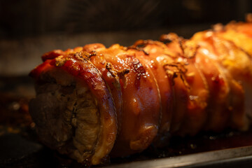 Baked pork wrapped in a roll. Pork roll close-up.