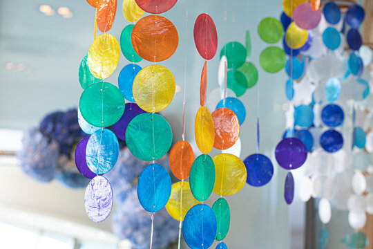 Mobile made of different colored transparent mother-of-pearl discs.