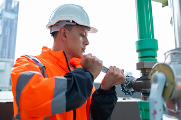 The engineer checks and adjusts the valve to allow the amount of water to flow through the CW bile...