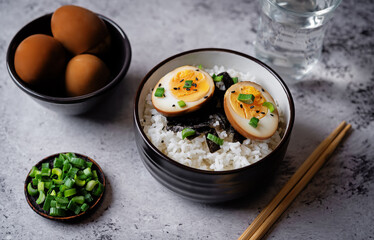 Tamago soy sauce eggs with rice and nori in a bowl