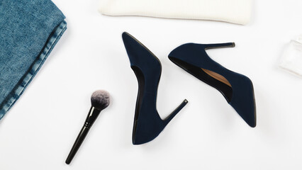 flat lay, blue jeans, high heels, with makeup and accessories on white background, Fashion concept
